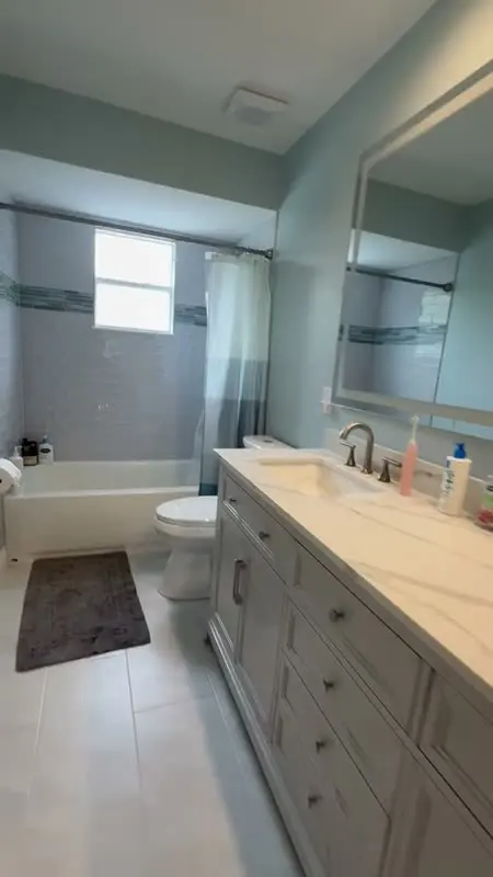 Remodeled bathroom with new vanity and tub