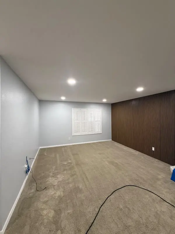 Interior repaint with a dark wood slat accent wall